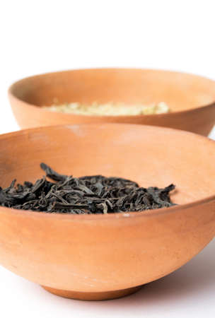 Dry tea leaves in the bowlの写真素材