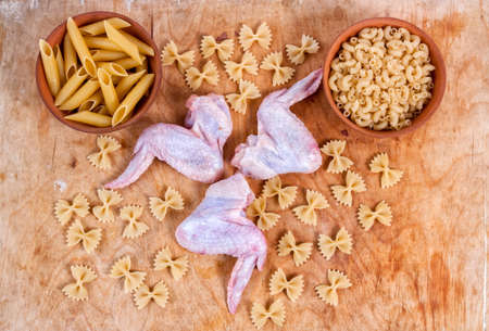 Baking ingedients. pasta on table with chickenの写真素材