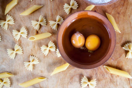 Baking ingedients. pasta on table with eggsの写真素材