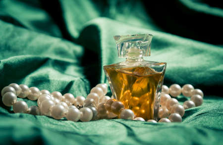 Pearls and perfume closeup on the silkの写真素材
