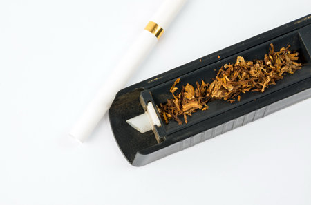 Tobbaco cigarette making machine on the white