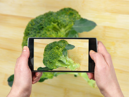 Taking picture with the phone. Brocolliの写真素材