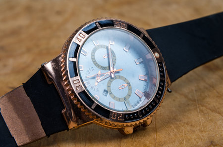 Business wristwatch on the wooden table
