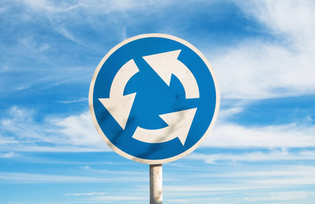Closeup of the roundabout sign in city