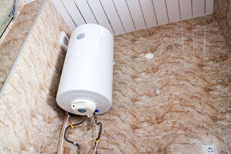 Hot water boiler tank in bathroomの写真素材
