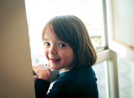 Little girl looking out the window