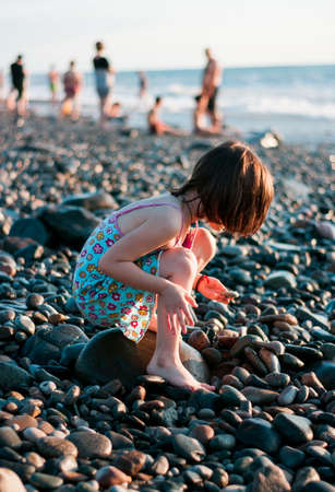 Little girl playing at the beachの写真素材