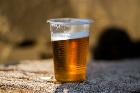 Plastic glass of the beer outdoorsの写真素材