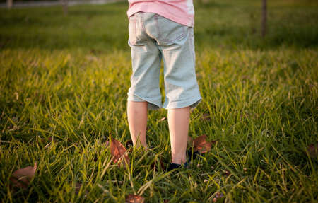 Little girls legs in the fieldの写真素材