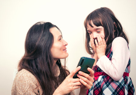 Mom with the kid and the phoneの写真素材