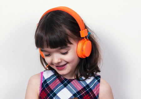 Little girl using the earphones