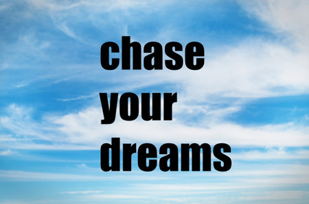 Chase your dreams quote on skyの写真素材