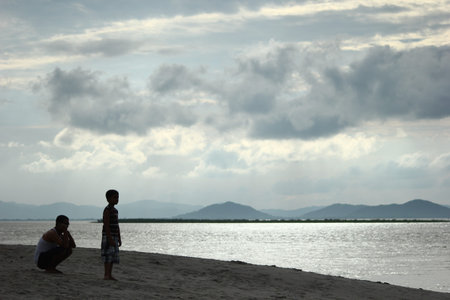 a father and a son enjoying the view of the river Brahmaputra at Tatimara Kamrup Assam