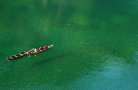 local people sailing across Umngot river at Dawki Meghalaya