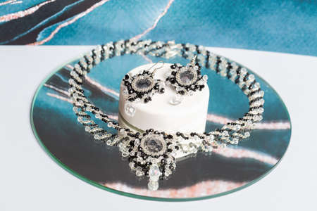 Handmade beaded bracelet. Close up. Clasp made of precious stone. On an unusual background.の写真素材
