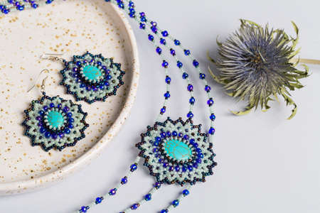 Braided bracelet made of white beads on the hand. Close-up.の写真素材
