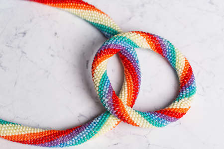 Braided bracelet made of white beads on the hand. Close-up.の写真素材