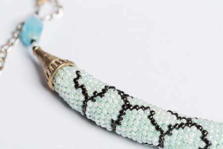 Braided bracelet made of white beads on the hand. Close-up.の写真素材