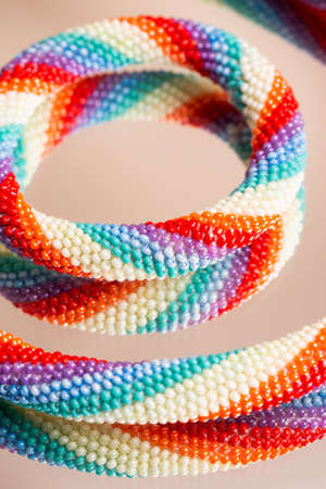 Braided bracelet made of white beads on the hand. Close-up.の写真素材