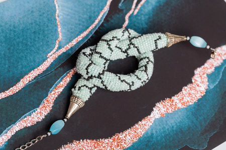 Braided bracelet made of white beads on the hand. Close-up.の写真素材