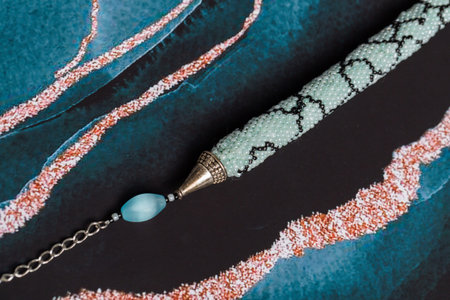 Braided bracelet made of white beads on the hand. Close-up.