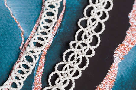 Braided bracelet made of white beads on the hand. Close-up.の写真素材