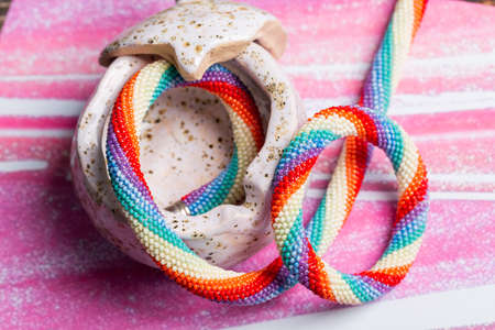Beaded bracelet in a porcelain box on a pink background. Close-upの写真素材