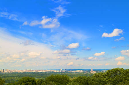 City landscape with beautiful spring blue sky and green trees.の写真素材