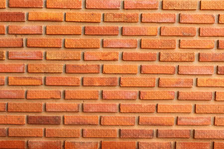 engraved bricks in the wall are orange backgroundの写真素材