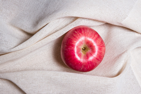 apple on white cream color fabricの写真素材