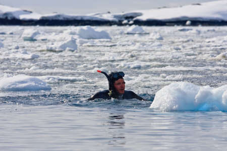 Diver among the ice against the blue iceberg. Antarcticaの写真素材