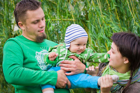 Happy family on a green backgroundの写真素材