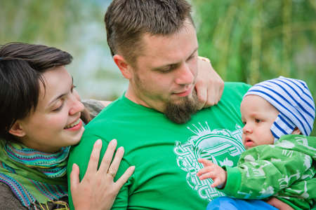 Happy family on a green backgroundの写真素材