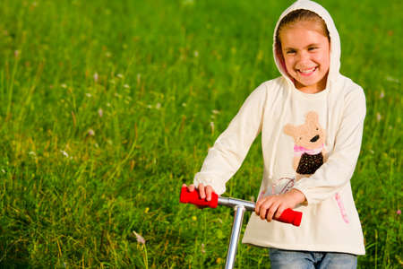 Beautiful happy little girl outdoorの写真素材