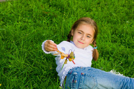 Beautiful happy little girl outdoor playingの写真素材