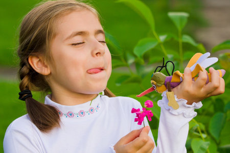 Beautiful happy little girl outdoor playingの写真素材