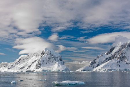 Beautiful snow-capped mountains against the blue skyの写真素材