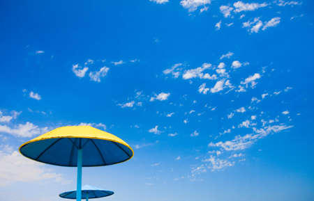 An umbrellas on a background of blue skyの写真素材