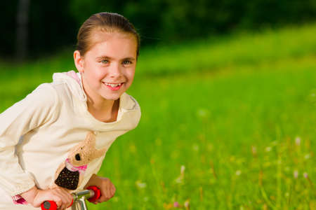 Beautiful happy little girl outdoorの写真素材