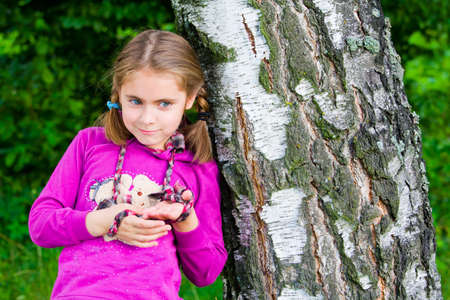 Beautiful happy little girl outdoor playingの写真素材