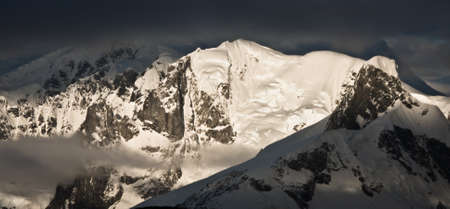 Beautiful snow-capped mountains against the blue skyの写真素材