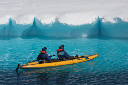 Two men in a canoe among icebergs in Antarcticaの写真素材
