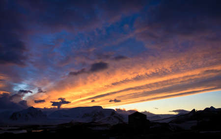 Beautiful sunset in Antarctica, mountains in the backgrounの写真素材