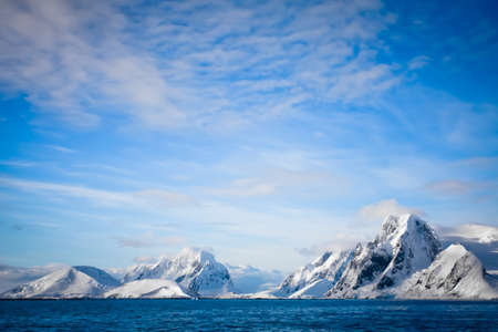 Beautiful snow-capped mountains against the blue skyの写真素材