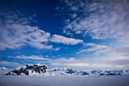 Beautiful snow-capped mountains against the blue skyの写真素材