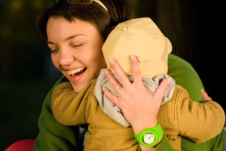 A mother and child playing in autumn parkの写真素材