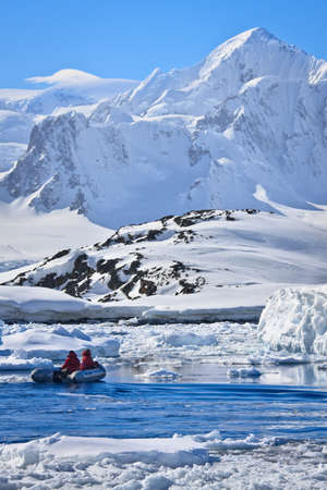 two men in the boat in Antarcticaの写真素材