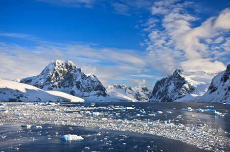 Beautiful snow-capped mountains against the blue sky in Antarcticaの写真素材