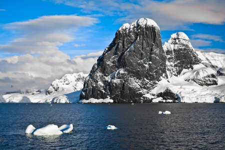 Beautiful snow-capped mountains against the blue sky in Antarcticaの写真素材