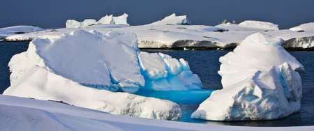 Huge icebergs in Antarctica, blue sky, azure water, sunny dayの写真素材